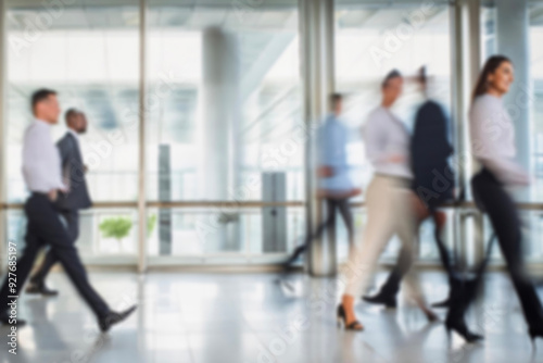 business people walking in the corridor of an business center, pronounced motion blur, crowded bright modern light office movement defocused. office background busy. talking and rushing in the lobby.