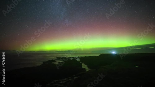  The Whalebone and sea view from birsay with dancing Aurora in 4k. photo