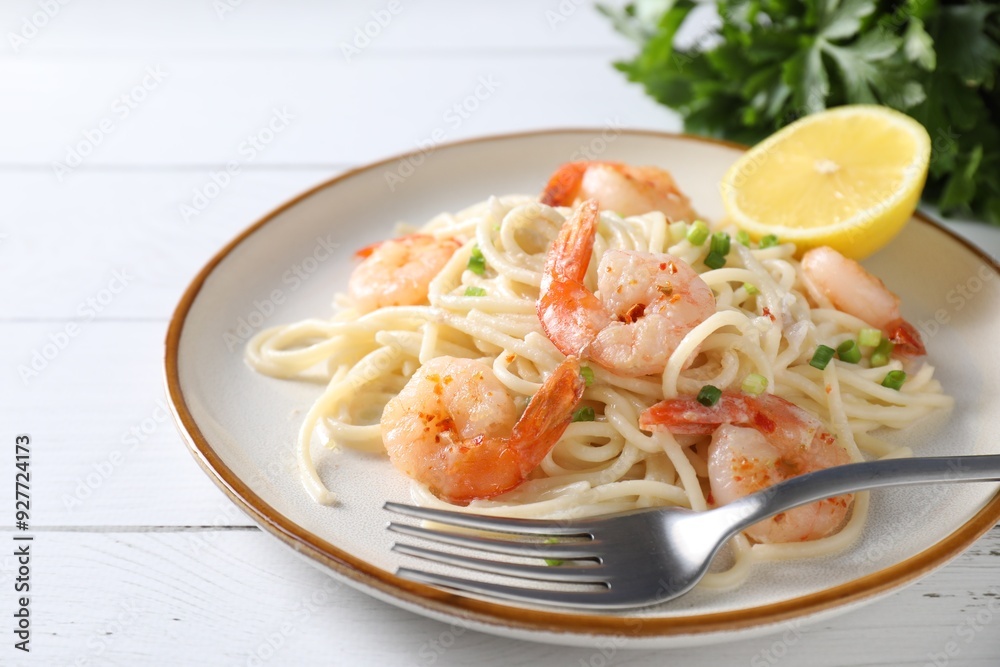 Delicious pasta with shrimps, green onion and fork on white wooden table, closeup Delicious pasta with shrimps, green onion and fork on white wooden table, closeup