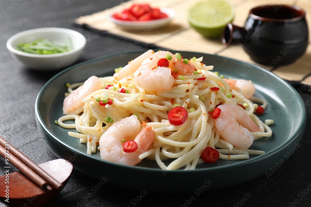 Delicious pasta with shrimps served on black table, closeup Delicious pasta with shrimps served on black table, closeup