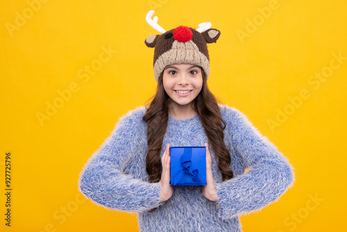 Teenager child with gift box. Present for holidays. Happy birthday, Valentines day, New Year or Christmas. Kid hold present box. Happy girl face, positive and smiling emotions.