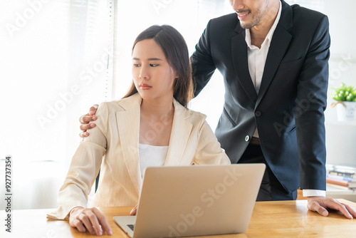 Disgusted asian young employee, pressure business woman uncomfortable, looking hand of boss or colleague  male when touching her shoulder, embrace. Sexual harassment inappropriate at office work.