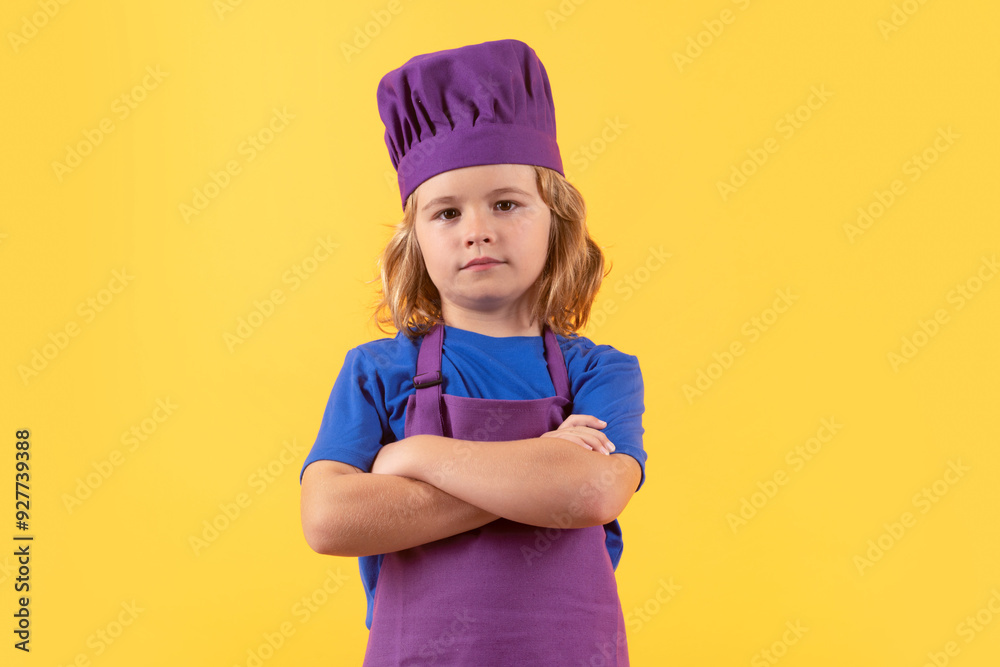 Chef kid boy making healthy food. Portrait of little child in chef hat isolated on studio background. Child chef. Cooking process. Chef kid boy making healthy food. Portrait of little child in chef hat isolated on studio background. Child chef. Cooking process.