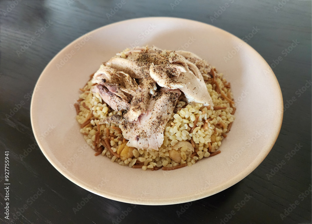 Turkish bulgur pilaf  topped with boiled chicken pieces