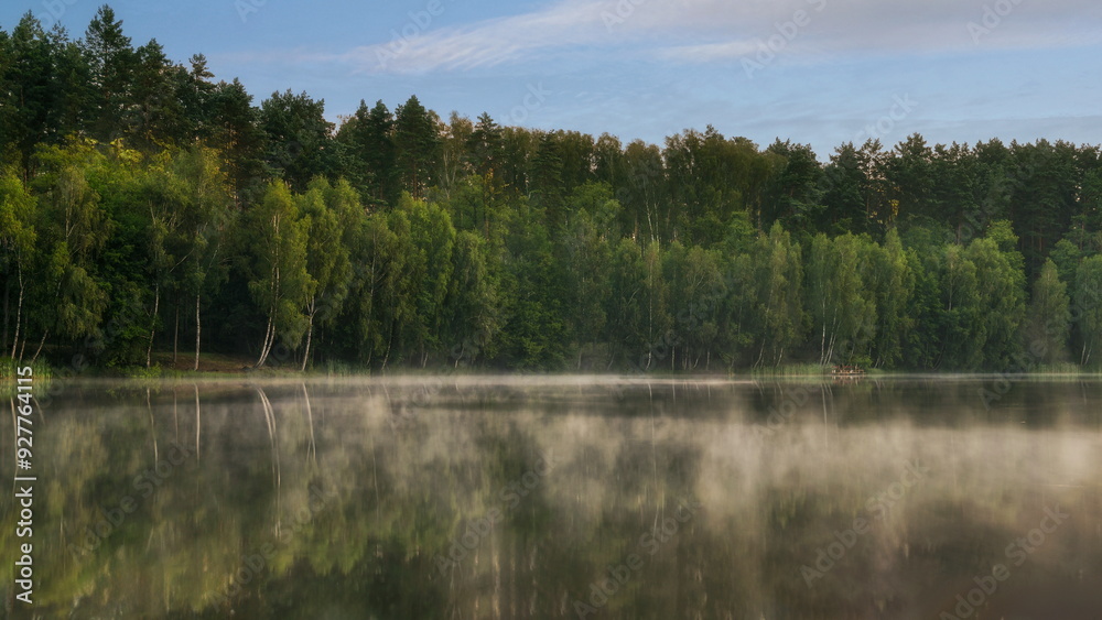 Obraz premium Morning over a forest lake with fog, in the Czlopa commune near Mielecin