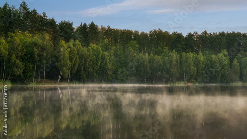 Morning over a forest lake with fog, in the Czlopa commune near Mielecin