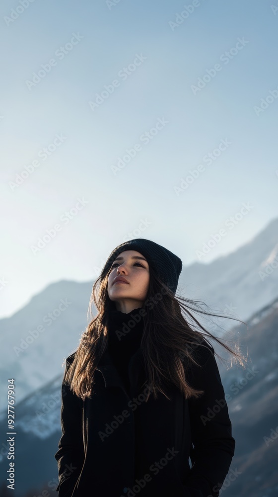 Young woman enjoying the scenic mountain view on a crisp winter day Young woman enjoying the scenic mountain view on a crisp winter day