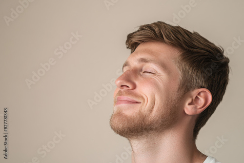 A close up of a man's face with his eyes closed