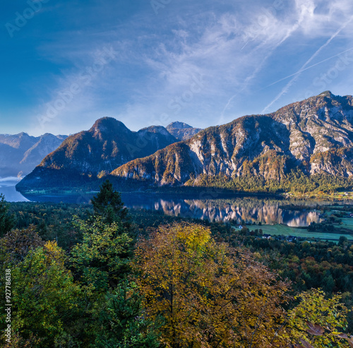 Peaceful morning autumn Alps mountain lake with clear transparent water and reflections. Hallstatter lake, Upper Austria.