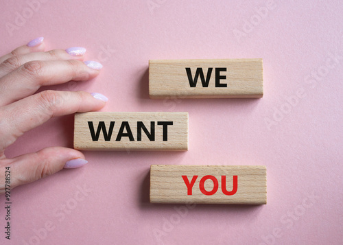 We want you symbol. Concept words We want you on wooden blocks. Businessman hand. Beautiful pink background. Business and We want you concept. Copy space.