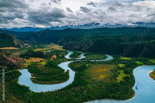 Winding River meander in mountains with forest trees, aerial top view landscape Altai