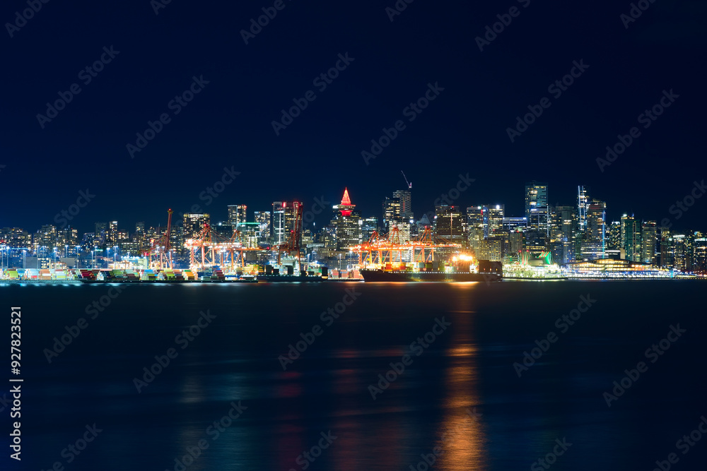 Night cityscape of Vancouver with colorful lights reflections on water at Harbour Centre, British Columbia, Canada Night cityscape of Vancouver with colorful lights reflections on water at Harbour Centre, British Columbia, Canada