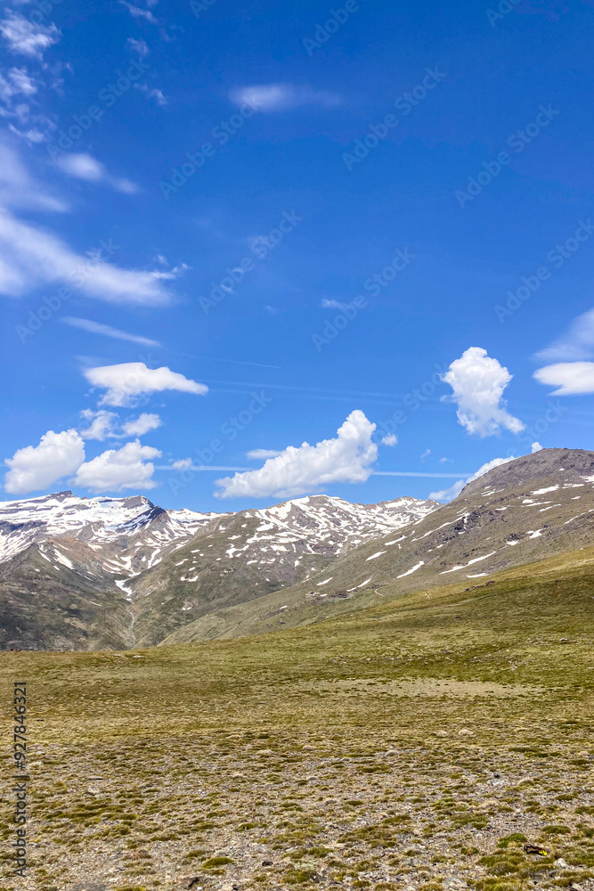 Fototapeta premium Panoramic view on snowy mountains on hiking trail to Mulhacen peak in the spring, Sierra Nevada range, Andalusia, Spain