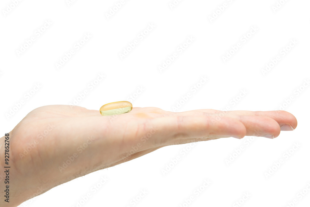 Male hand holding omega 3 soft gel capsule isolated on white background Male hand holding omega 3 soft gel capsule isolated on white background
