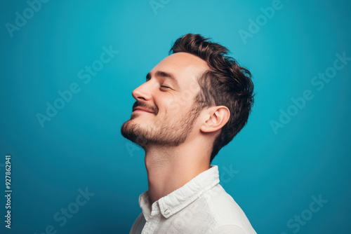 A close up of a man's face with his eyes closed