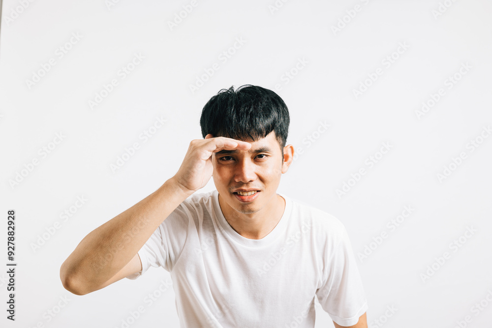 Portrait Asian smiling young man trying to see something into distance holds palm on forehead studio isolated white background, Happy lifestyle men carry person hand and search in distance Portrait Asian smiling young man trying to see something into distance holds palm on forehead studio isolated white background, Happy lifestyle men carry person hand and search in distance