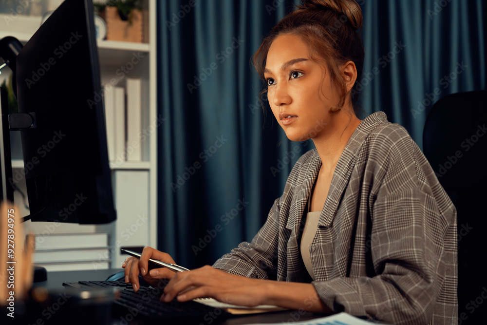 Businesswoman working on computer with stretching arm up and down manner with body health ache of strain overwork unfinished project job on website at late over night time at modern office. Infobahn. Businesswoman working on computer with stretching arm up and down manner with body health ache of strain overwork unfinished project job on website at late over night time at modern office. Infobahn.