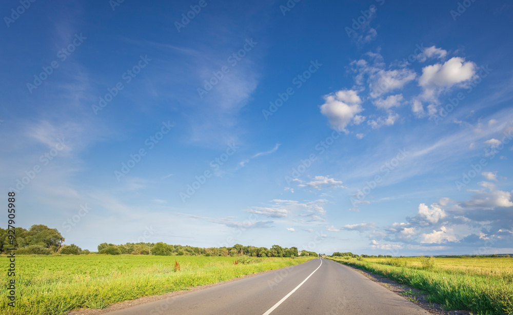 Fototapeta premium A long road with a clear blue sky above it