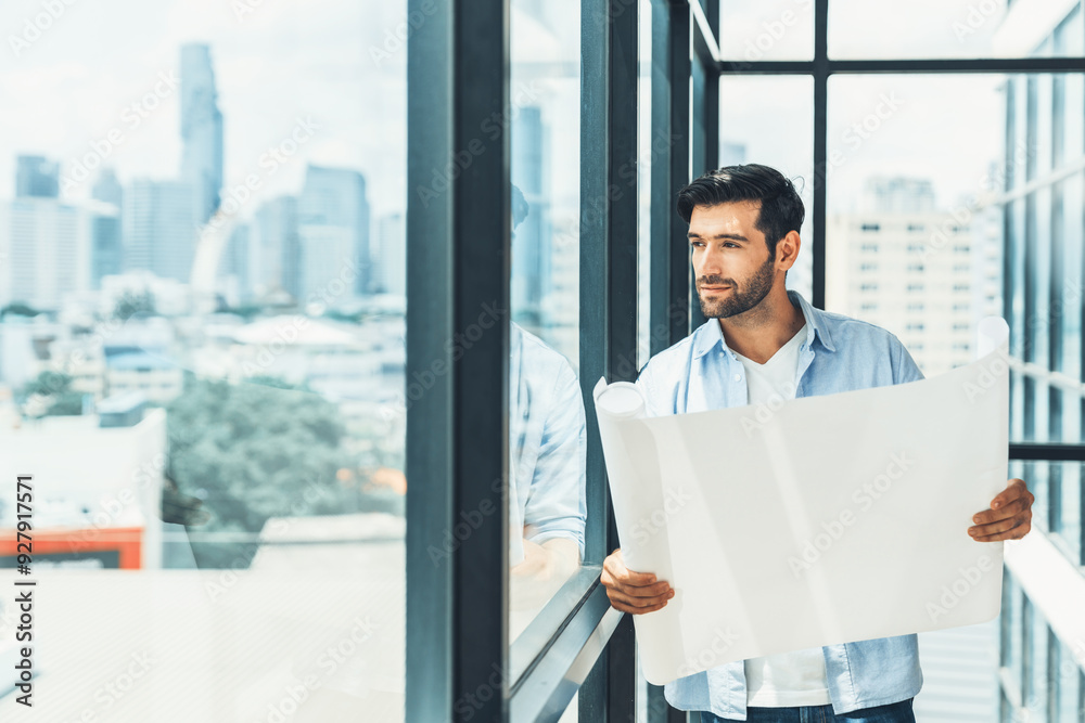 Fototapeta premium Professional architect engineer or male worker in casual outfit looking at skyscraper and city view while holding project plan. Creative design, civil engineering, building construction. Tracery.
