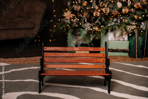 A miniature wooden bench set against a festive background, perfect for Christmas or holiday-themed projects. photo