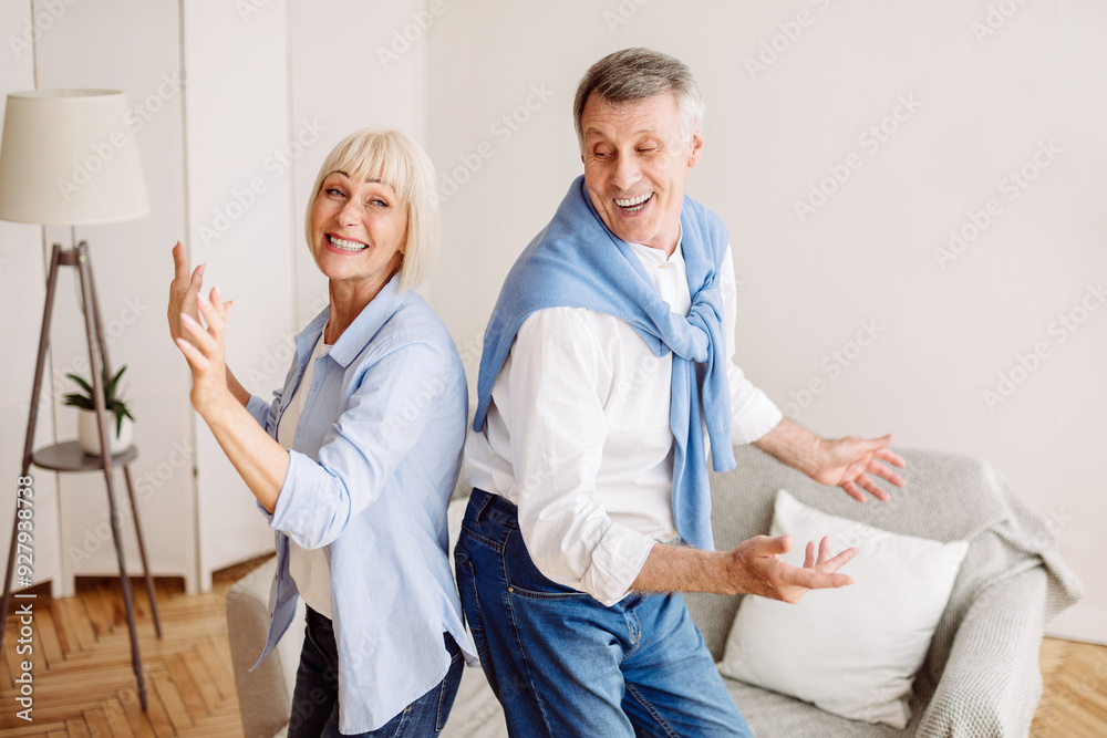 Fototapeta premium Senior couple dancing active dance at home, having fun at retirement, free space