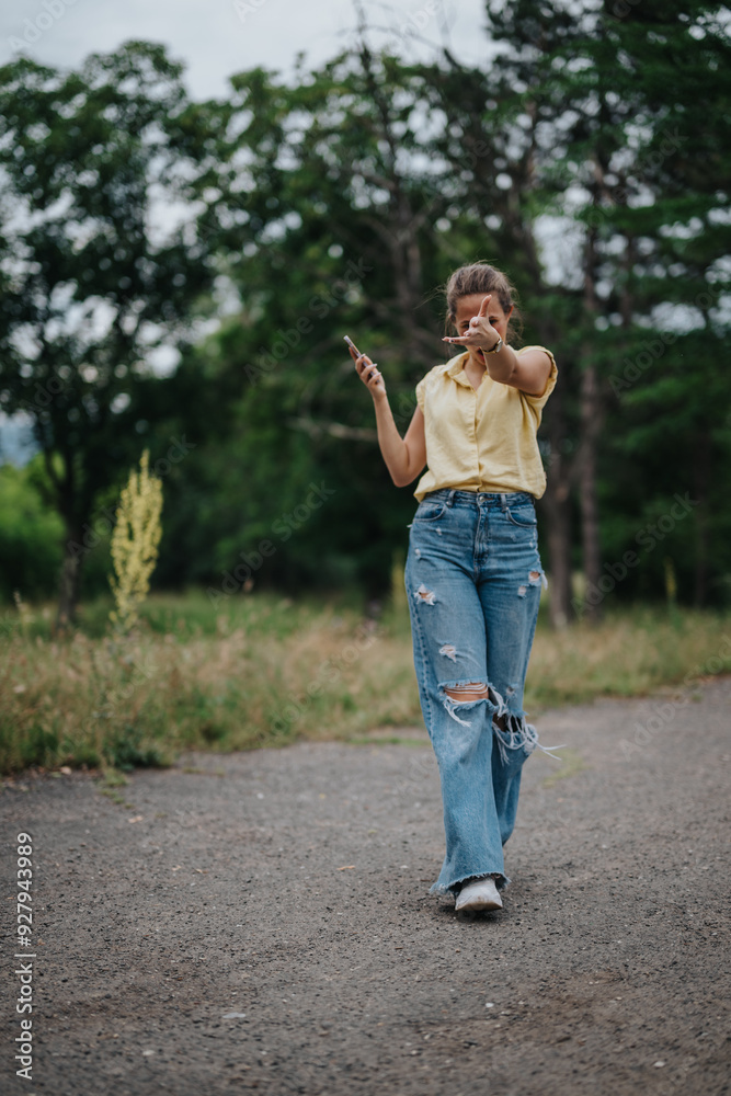 A cheerful girl enjoying time alone in the park, dressed in casual clothes and playfully pointing at the camera. A cheerful girl enjoying time alone in the park, dressed in casual clothes and playfully pointing at the camera.