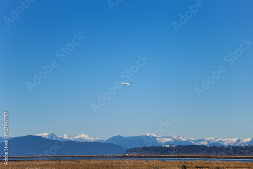 airplane flies over the snow mountains