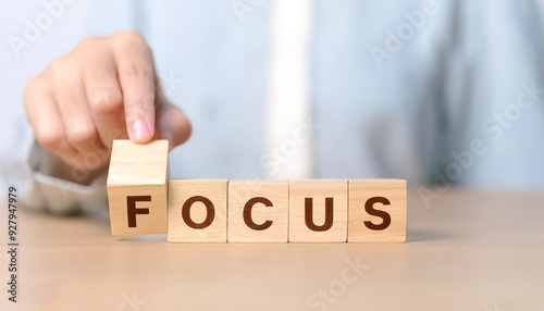 Focus management concept. hand put focus word on wooden block cube