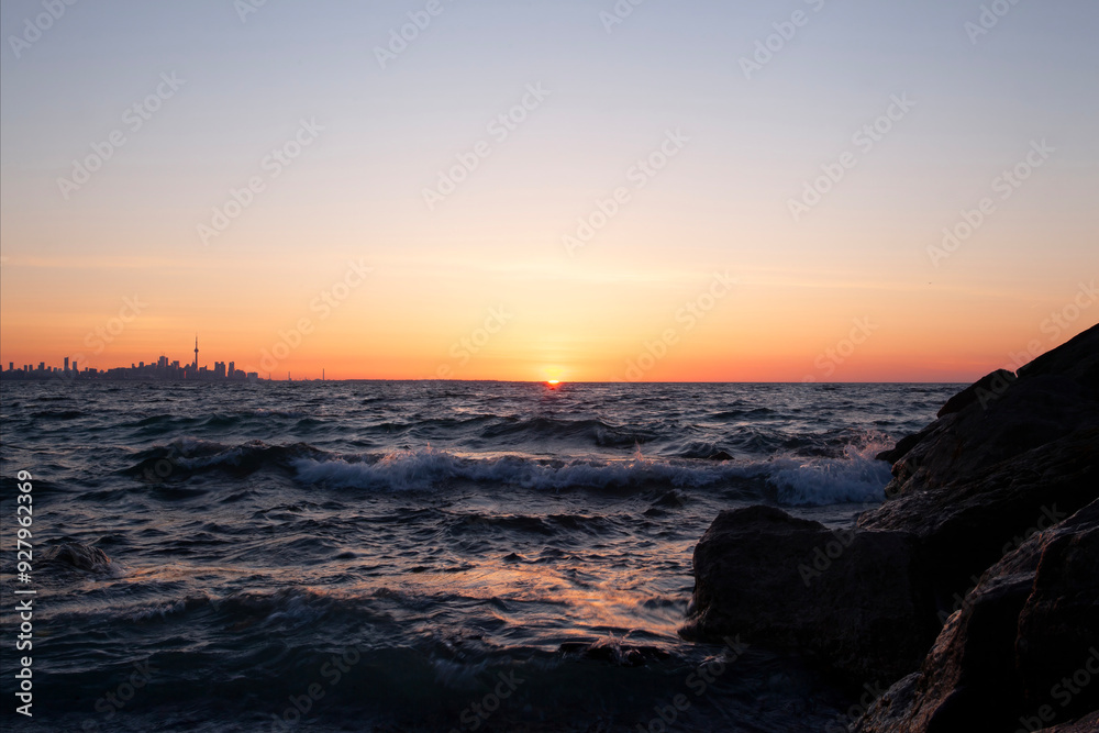 Looking east toward the Toronto Ontario Canada skyline at sunrise from Colonel Samuel Smith Park Looking east toward the Toronto Ontario Canada skyline at sunrise from Colonel Samuel Smith Park