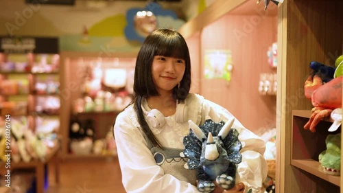 A young Taiwanese woman in her twenties browses and tries various products at a souvenir shop in Shilin District, Taipei City. photo