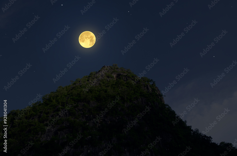 Fototapeta premium Bright full moon over mountaintop in the night