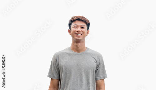 Young man in gray t-shirt smiling happily isolated on gray background. Happy man. Positive person.