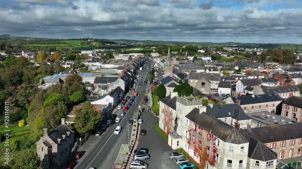 Carrickmacross Town, County Monaghan, Ireland, November 2022. Drone pushes north above St Finbarr’s Church of Ireland over the main street revealing houses along both sides of the rural market town. Carrickmacross Town, County Monaghan, Ireland, November 2022. Drone pushes north above St Finbarr’s Church of Ireland over the main street revealing houses along both sides of the rural market town.
