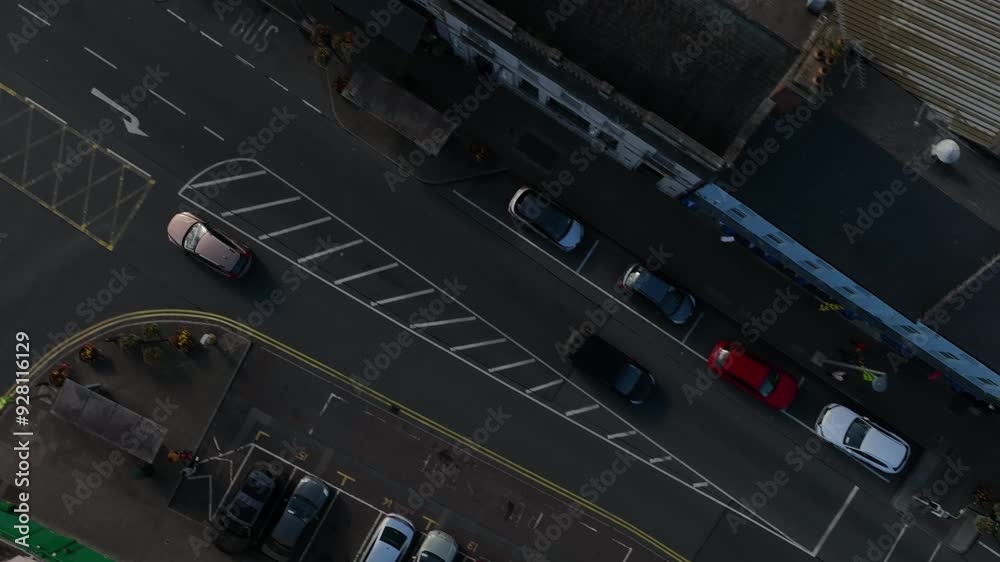 Carrickmacross Town, County Monaghan, Ireland, November 2022. Drone in Bird's Eye View pushes along main street following cars driving through the rural market town. Carrickmacross Town, County Monaghan, Ireland, November 2022. Drone in Bird's Eye View pushes along main street following cars driving through the rural market town.
