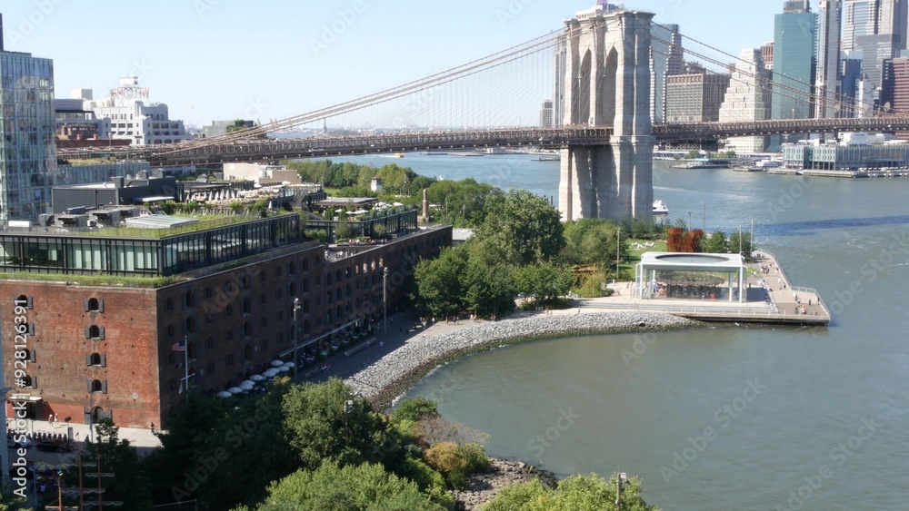Obraz premium Brooklyn Bridge from Manhattan Bridge. New York City downtown skyline, financial district cityscape, World Trade Center. Travel USA. Architecture by East River water, United States. Dumbo carousel.