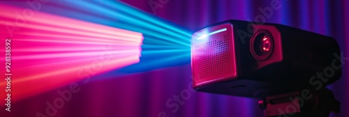 A small projector is projecting red and blue light beams on a purple background, symbolizing creativity, innovation, entertainment, technology and projection. photo