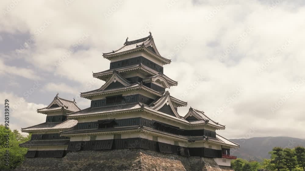 Pan upwards of Matsumoto Castle - slow movement during midday Pan upwards of Matsumoto Castle - slow movement during midday