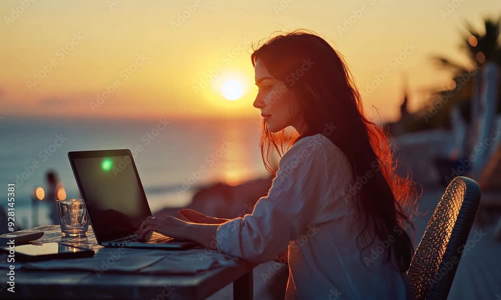 Young business woman working at the computer in cafe on the rock. Young girl downshifter working at a laptop at sunset or sunrise on the top of the mountain to the sea, working day