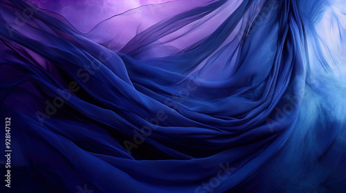 The image showcases a flowing, ethereal arrangement of sheer fabric in varying hues of deep blue and purple. The delicate layers of fabric create a sense of motion and fluidity, reminiscent of waves o photo