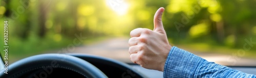 person giving the thumbs up while driving in their car