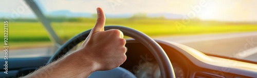 person giving the thumbs up while driving in their car