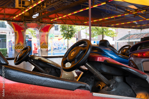 Empty bumper cars at a funfair, waiting for customers photo