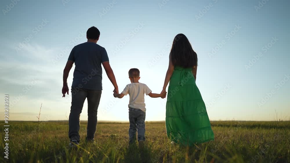 family walking in park. Parents child holding hands together at sunset. Family enjoying quality time outdoors. Scenic sunset family bonding moment. Togetherness in nature. Lifestyle park family walk. family walking in park. Parents child holding hands together at sunset. Family enjoying quality time outdoors. Scenic sunset family bonding moment. Togetherness in nature. Lifestyle park family walk.
