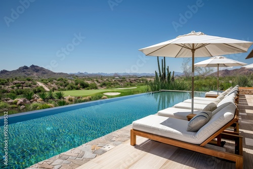 Elegant wooden and white poolside lounge chairs with umbrellas  overlooking a golf course in Baja California s red mountains.