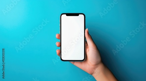 A hand holding a smartphone with a blank white screen on a blue background.