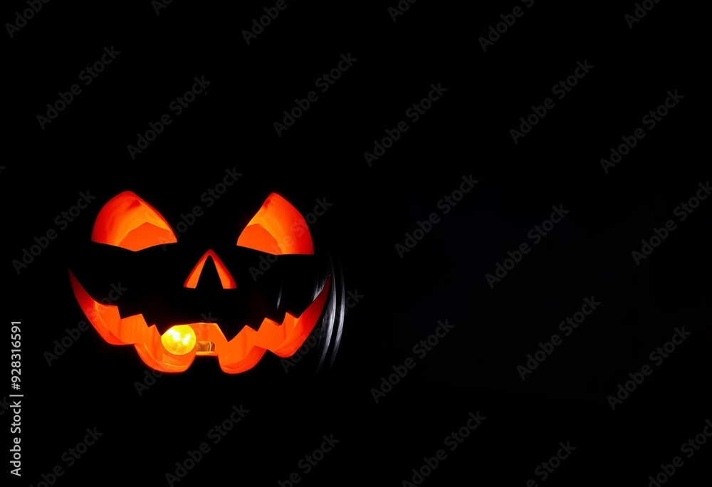 “A glowing jack-o-lantern with a scary face sits on a dark night during Halloween” “A glowing jack-o-lantern with a scary face sits on a dark night during Halloween”