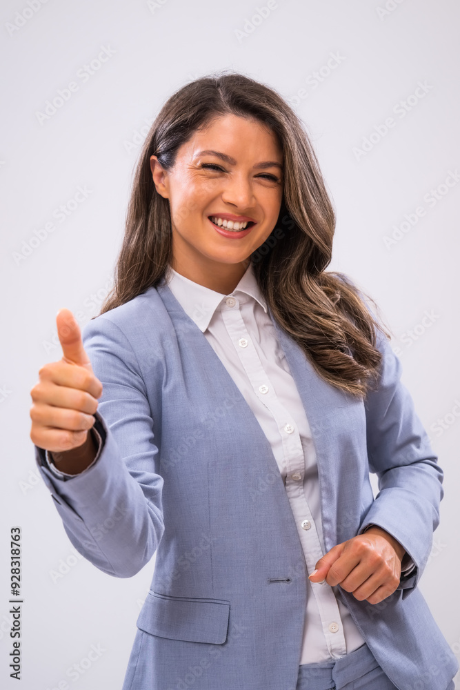 Portrait of cheerful businesswoman who is looking at camera and showing thumbs up. Portrait of cheerful businesswoman who is looking at camera and showing thumbs up.