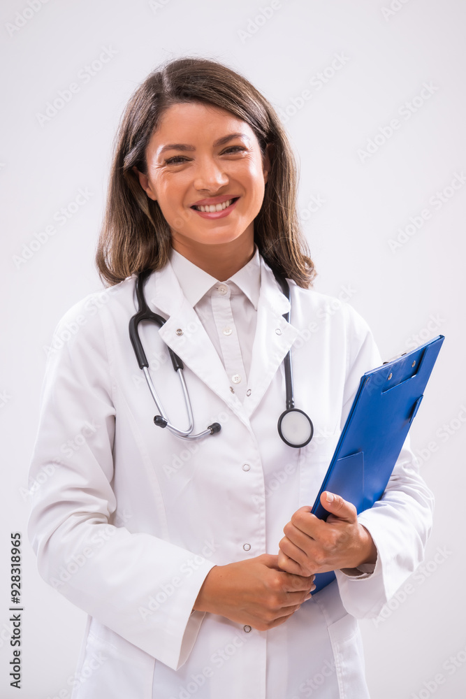 Portrait of doctor who is holding clipboard and smiling. Portrait of doctor who is holding clipboard and smiling.