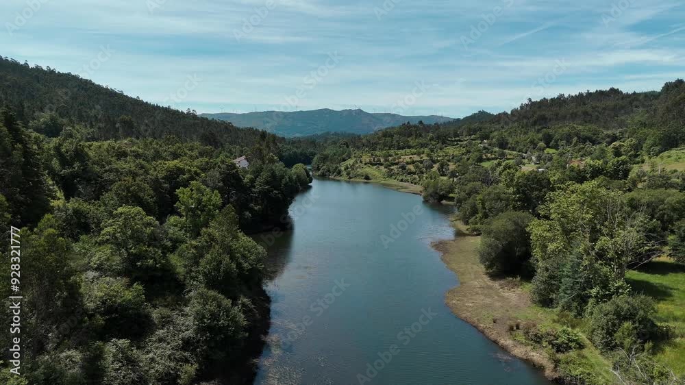 Serene river winding through lush greenery in Gerês, Portugal Serene river winding through lush greenery in Gerês, Portugal