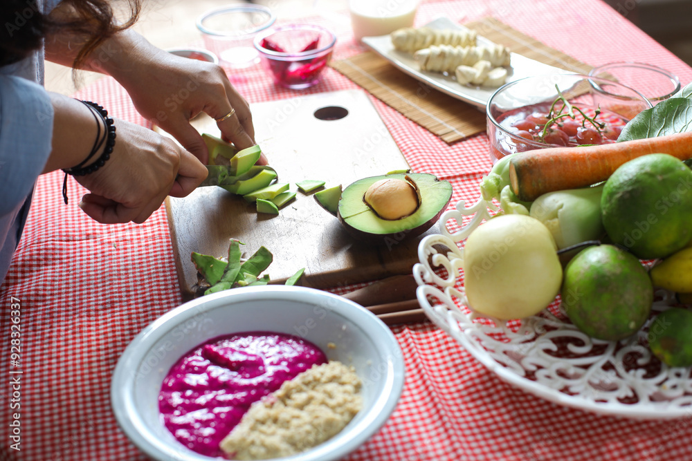 Woman Slicing Avocado On Cutting Board For Preparing Mix Fruit Woman Slicing Avocado On Cutting Board For Preparing Mix Fruit